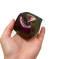 A colour-shifting PolySquish Discovery Series #2 shape resting in an open hand