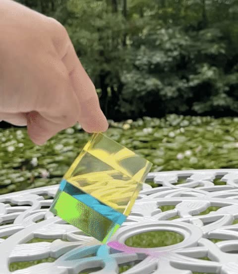 Animated view of The Original CMY Cube rotating, cyan, magenta and yellow shifting as light passes through